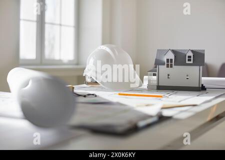 Nahaufnahme eines Entwurfs des architektonischen Plans mit Hausanordnung, Helm und Ingenieur-Werkzeugen. Stockfoto
