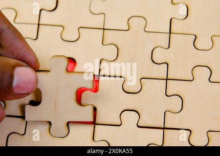 Verbinden Sie die letzten Teile eines Puzzles und symbolisieren Teamarbeit, Zusammenarbeit und erfolgreiche Problemlösung in einem Geschäftskonzept. Stockfoto