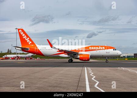 Ein EasyJet Flugzeug in seiner markanten weiß-orange Lackierung, das am Flughafen Birmingham fährt Stockfoto