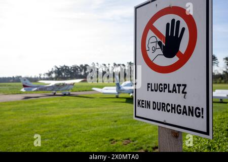 Flugplatz Ansbach Petersdorf, Deutschland. April 2024. Mehrere Flugzeuge parken hinter einem Schild mit der Aufschrift „Airfield, no Passage!“. Quelle: Pia Bayer/dpa/Alamy Live News Stockfoto