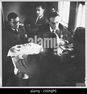 Fotografisches negativ, das Passagiere in Berwick während eines Transatlantikflugs zeigt, während sie sich nach einer Mahlzeit im Jahr 1945 im Rauchraum unterhalten. Stockfoto