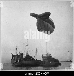 BALLONSCHUTZ FÜR KANALKONVOIS - zur Geschichte siehe CH.4940 zurück im Hafen - ein Ballon wird zur Inspektion von seinem Schiff entfernt. Fotografisches negativ, Royal Air Force Stockfoto