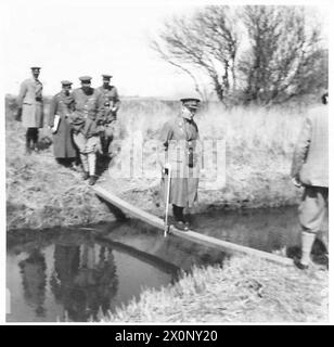 LORD GORT INSPIZIERT EINEN ARTILLERIEBEREICH - Lord Gort überquert einen Deich an einer Stegbrücke. Fotografisches negativ, britische Armee Stockfoto