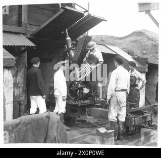 AUF Einem PROOF-BEREICH - Eine Bofors-Waffe wird in die Hintern geschossen. Laden der Granaten in eine Bofors-Waffe, während sie getestet wird. Fotografisches negativ, britische Armee Stockfoto