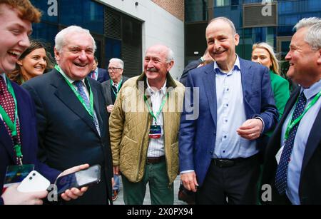 Der ehemalige Taoiseach Bertie Ahern trifft und schüttelt die Hände mit dem derzeitigen Fianna Fail Leader und Tanaiste Micheal Martin, als er am Fianna Fail Ard Fheis im Dublin Royal Convention Centre ankommt. Bilddatum: Samstag, 13. April 2024. Stockfoto