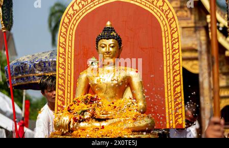 Chiang Mai, Thailand. April 2024. Thailänder bieten Blumen während der Prozession der Phra Buddha Sihing Buddha Statue an, um die Songkran-Feierlichkeiten im Tempel Wat Phra Singh Woramahaviharn zu feiern. Das festliche Songkran ist auch bekannt als das Wasserfest, das am traditionellen thailändischen Neujahrstag jedes Jahr am 13. April gefeiert wird, indem Wasser gespritzt und Pulver auf die Gesichter geworfen wird, als symbolisches Zeichen für die Reinigung und das Abwaschen der Sünden aus dem vergangenen Jahr. (Credit Image: © Pongmanat Tasiri/SOPA Images via ZUMA Press Wire) NUR REDAKTIONELLE VERWENDUNG! Nicht für kommerzielle ZWECKE! Stockfoto