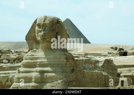 Die berühmte große Sphinx im Vordergrund mit der Pyramide von Gizeh, die sich majestätisch in der Ferne erhebt Stockfoto