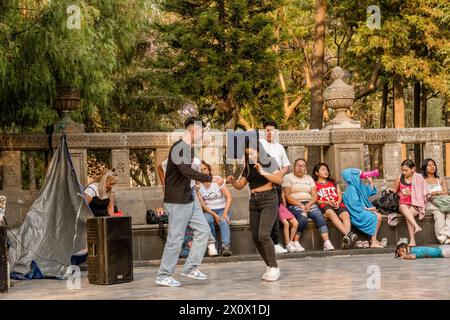 Leute tanzen im Alameda Central, einem wunderschönen Stadtpark. Alameda Central in Mexiko City ist ein historischer Stadtpark aus dem 16. Jahrhundert, der ihn zu einem der ältesten öffentlichen Parks Amerikas macht. Mit üppigem Grün, kunstvollen Springbrunnen und Statuen bietet es eine ruhige Oase im Herzen der belebten Metropole, die Einheimische und Touristen gleichermaßen für gemütliche Spaziergänge und Entspannung anlockt. Stockfoto