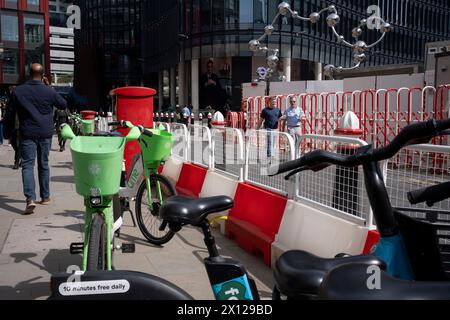 Vermietung von E-Bikes, Fußgängern und einer kugelförmigen Skulptur am Broadgate und Liverpool Street Statio in der City of London, dem Finanzviertel der Hauptstadt, am 12. April 2024 in London, England. Stockfoto