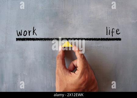 Draufsicht eines handhaltenden Holzdreiecks. Work-Life-Balance-Konzept. Stockfoto