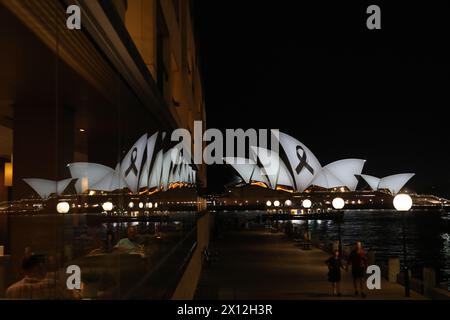 Sydney, Australien. April 2024. Am Montagabend wurde ein schwarzes Band auf die Segel des Opernhauses von Sydney projiziert, als Teil einer Lichtshow, um den Opfern des Angriffs auf die Einkaufszentren in Sydney zu Tribut zu zollen. Ein geistig kranker Messerangreifer (möglicherweise auf Drogen), der 40-jährige Joel Cauchi, ging am Samstag, den 13. April 2024, in Bondi Westfield auf einen Amoklauf und tötete 6 Menschen. Im Bild: Im Fenster des Park Hyatt Hotels. Richard Milnes/Alamy Live News Stockfoto