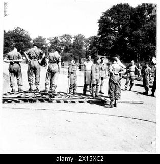 Eine SPEZIALDIENSTBRIGADE BEREITET SICH AUF DIE AKTION VOR - Eine kleine tragbare Brücke zum Überqueren von Panzerfallen, Strömen usw. wird Generalmajor R. Sturgess, CB.,DSO.,ADC, bei seinem Besuch in der Brigade demonstriert. Bei ihm ist Brigademeister Lord Lovat, DSO, MC British Army Stockfoto