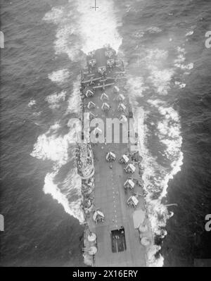 MIT DER BRITISCHEN MARINE IM OSTEN. MÄRZ BIS MAI 1945, AM ROYAL MARINEFLUGBAHNHOF COLOMBO, AN BORD DES BEGLEITSCHIFFS HMS EMPRESS USW. - Blick von einem Marineflugzeug auf dem Zufall-Vought Corsair und Fairey Barracuda gepackten Deck des britischen Flugzeugträgers HMS INDOMITABLE Royal Navy, HMS Indomitable, Aircraft Carrier, (1940) Stockfoto