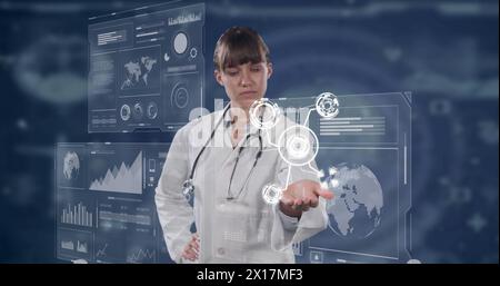 Bild einer kaukasischen Ärztin mit Symbolen über digitalen Bildschirmen mit verschiedenen Daten Stockfoto