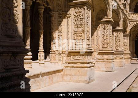 Altes Gebäude mit Säulen und Bögen, dekoriert mit architektonischen Details im Innenhof des Klosters Jeronimos in Lissabon, Portugal Stockfoto