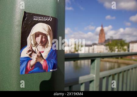 Frankfurt am Main, Deutschland. April 2024. Mutter-Maria-Aufkleber im Vordergrund und Skyline von Frankfurt am Main im Hintergrund. Stockfoto