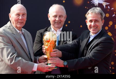 Berlin, Deutschland. März 2014. Die ehemaligen Fußballnationalspieler und Weltmeister Horst Eckel (1954), Bernd Hölzenbein (1974) und Pierre Littbarski (1990) präsentieren am 29.03.2014 die ursprüngliche Trophäe der FIFA Fussball-Weltmeisterschaft am Flughafen Berlin-Tegel. Hölzenbein starb im Alter von 78 Jahren. Quelle: Picture Alliance/dpa/Alamy Live News Stockfoto