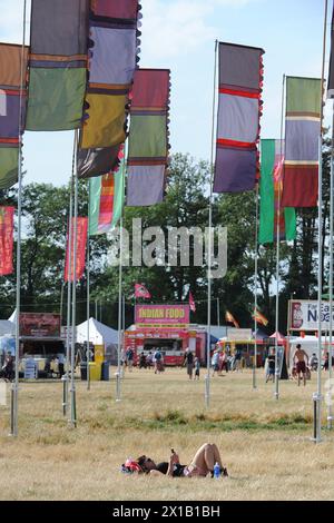 Während des WOMAD Festivals 2013 im Charlton Park in Wiltshire entspannen sich Festivalbesucher in der Sonne. Stockfoto
