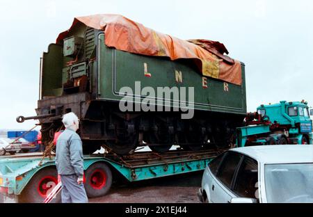 Die Dampflokomotive Flying Scotsman wird von dem französischen Containerschiff CGM La Perouse bei Tilbury Docks entladen. Die Lokomotive war während der Teilnahme an den Feierlichkeiten zum zweihundertjährigen Jubiläum Australiens im Jahr 1988 durch das Land gereist. LNER Klasse A3 4472 fliegende Schotte. Kohletender am Tieflader Stockfoto