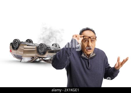 Schockierter reifer Mann mit einer Brille, wie ein Auto isoliert auf weißem Hintergrund stürzt Stockfoto