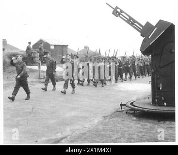 Mitglieder der Heimgarde, die bemannte Raketenprojektoren und Flugabwehrkanonen betreiben, marschieren an Brigadier V.R. Krohn, MCTD, vorbei, während eines Saluts in Übungen der britischen Armee. Stockfoto