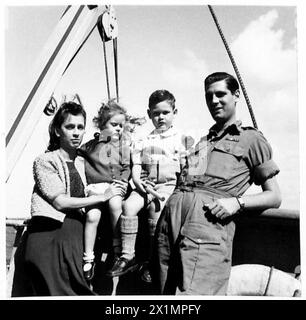 Ehemalige Kriegsgefangene und zivile Internierte kehren an Bord des Schiffes aus den Gefängnislagern in Singapur zurück, darunter Gunner W. Bryant mit seiner Frau und zwei Kindern. Stockfoto