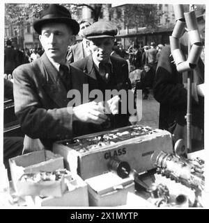 SONNTAG-MORGEN-MARKT IN BRÜSSEL: Diese Fotoserie in Brüssel zeigt einen typischen Sonntag-Morgen-Markt. Es ist sehr ähnlich wie unsere Petticoat Lane, wo man fast alles kaufen kann. Viele belgische Volksgruppen drängen auf dem Markt auf der Suche nach Artikeln wie Büchern, Eisenwaren, Fahrradteilen, Obst und vielen anderen Artikeln, die sie brauchen. In dieser Serie wird eine allgemeine Ansicht einer Straße gezeigt, in der der Brüsseler Schwarzmarkt weitergeführt wurde. Kein Schwarzmarkt, wie wir es verstehen, aber wo belgische Leute mit Lebensmitteln usw. versorgt wurden, war das von den Deutschen verboten. [DIESE FOTOS SIND ZU ERLEUCHTEN Stockfoto