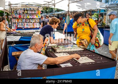 Touristen/Besucher kaufen Schmuck an Einem Verkaufsstand auf dem Ipanema Sunday Market (Hippie Fair) in Rio de Janeiro, Bundesstaat Rio de Janeiro, Brasilien. Stockfoto
