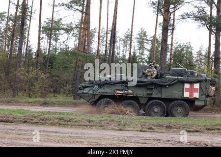 Ein US-Soldat, der dem 2. Kavallerie-Regiment zugewiesen ist, manövriert ein Stryker-gepanzertes Fahrzeug während einer kombinierten Waffen-Feuerübung im Rahmen von Saber Strike 24 auf dem Bemowo Piskie Training Ground, Polen, am 16. April 2024 durch ein raues Gelände. Der Stryker wird als medizinisches Evakuierungsfahrzeug eingesetzt und ist daher nicht mit Waffen ausgestattet. DEFENDER ist die Dynamic Employment of Forces to Europe for NATO Deterrence and Enhanced Readiness (dynamische Beschäftigung der Streitkräfte in Europa für Abschreckung und verbesserte Bereitschaft der NATO) und ist eine von der US-Armee geplante Übung, die aus Saber Strike, Sofortreaktion und Swift Res besteht Stockfoto