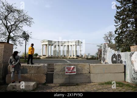 Odessa, Ukraine. April 2024. Eine Frau mit einem Kind steht am Betonzaun, der den Durchgang zur Woronzow-Kolonnade am Ende des Prymorskyi-Boulevards begrenzt. Der Worontsow-Palast ist ein Palast und Kolonnade aus dem 19. Jahrhundert in Odesa, Ukraine, am Ende des Prymorskyi-Boulevards, der seit Beginn der vollständigen Invasion der Russischen Föderation in das Gebiet der Ukraine für die Öffentlichkeit gesperrt ist. (Foto: Viacheslav Onyschtschenko/SOPA Images/SIPA USA) Credit: SIPA USA/Alamy Live News Stockfoto