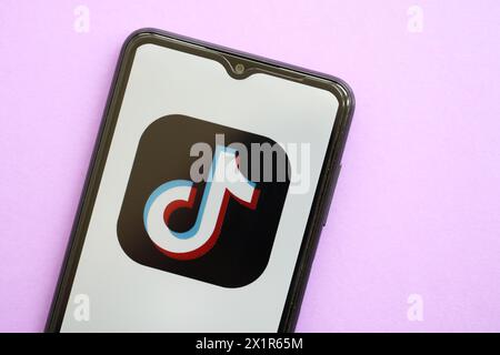 KIEW, UKRAINE - 1. APRIL 2024 TikTok oder Douyin Symbol auf Smartphone-Bildschirm auf lila Tisch Nahaufnahme. IPhone-Display mit App-Logo auf lilafarbenem Hintergrund Stockfoto