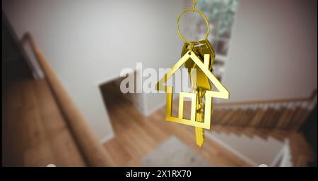 Das Kind hält einen Schlüsselanhänger in der Form eines goldenen Hauses und verwischt die Treppe im Hintergrund Stockfoto