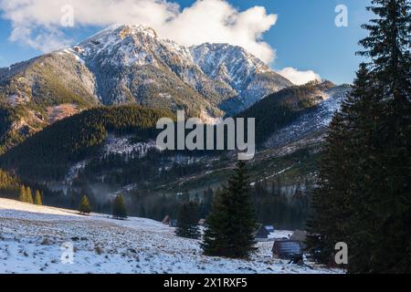 Polana Chocholowska im Winter sonniger Tag, westliche Tatra, Polen. Das Tal und alte Holzhütten, die mit Schnee bedeckt sind Stockfoto