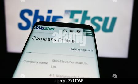 Mobiltelefon mit Website des japanischen Chemieunternehmens Shin-Etsu Chemical Co. Ltd. Vor dem Geschäftslogo. Fokussieren Sie sich oben links auf der Telefonanzeige. Stockfoto