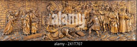 MAILAND, ITALIEN - 5. MÄRZ 2024: Das geschnitzte Relief Fall Jesu unter dem Kreuz in der Kirche Chiesa di San Camillo von Annibale Pagnoni (1900). Stockfoto