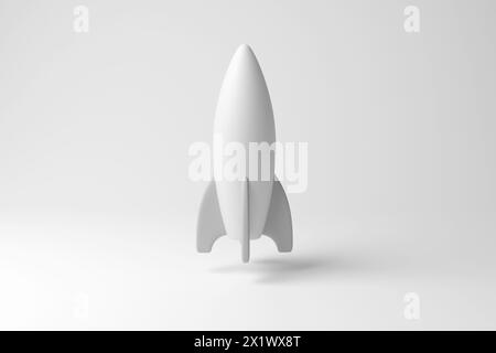 Weißes, raketenähnliches Raumschiff, das in der Luft auf weißem Hintergrund schwebt, in Monochrom und Minimalismus. Astrologie, Weltraumforschung und Technologie Stockfoto