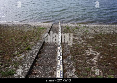 Messen, Waagen und Abmessen des Wasserstands. Küste und Ufer von Fluss, See, Damm, Wasserreservoir, Meer und Ozean. Stockfoto