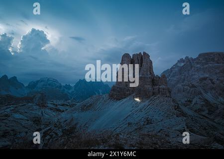 Beschreibung: Kopfwanderwege von Bergsteigern, die auf Dolomiten-Wanderwegen mit einem Gewitter im Hintergrund wandern. Drei Zinnen, Dolomiten, Süd-Ti Stockfoto