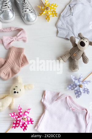 Babykleidung mit Strickspielzeug Hund und Kaninchen, Windmühlen für Spielzeug und Babyschuhe und Accessoires. Set mit Babykleidung und Accessoires für den Sommer. Spac kopieren Stockfoto