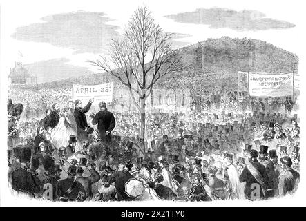 The Shakspeare Commemoration in London: Planting an Oak on Primrose Hill, [London], 1864. Das Komitee der Arbeiter pflanzt eine Eiche '...in zu Ehren des englischen Dichters... Mr Phelps, der populärste englische Shakspearean Schauspieler, hatte zugestimmt, das Büro zu übernehmen... die Südwand des Hügels war mit Menschen bedeckt... Ein großer quadratischer Raum, unterhalb des steilen Anstiegs, war mit einem Eisengeländer verschlossen und für diejenigen reserviert, die ihren Schilling bezahlten, um hineinzugehen... Mr. George Cruikshank... trug seine Freiwilligenuniform... aber Mr. Phelps, der zu Recht ein Favorit der Londoner Arbeiter ist, die es haben Stockfoto