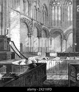 Innenraum der Romsey Abbey Church, 1865. "Die Abteikirche... ist eines der interessantesten Denkmäler normannischer kirchlicher Architektur, die zur Klosterklasse der Gebäude gehört, die in diesem Land erhalten sind; obwohl ein Teil des Kirchenschiffs auf einen späteren Stil verweisen muss... hat das Innere einen großen und edlen Aspekt, weist aber einige bemerkenswerte Besonderheiten auf: der Chor ist ungewöhnlich kurz, reicht nur wenige Meter zurück und jedes Querschiff wird durch eine kreisförmige Apsis abgeschlossen. Das Triforium besteht aus einem großen Rundbogen mit zwei Bögen darunter und hat eine leichte und anmutige Wirkung. Hinter dem Stockfoto