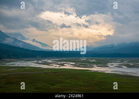 Atemberaubende Herbstausblicke entlang der Maligne Lake Road im Herbst an bewölkten, stimmungsvollen Tagen mit riesigen Berggipfeln und Wildnislandschaft in der Ferne. Stockfoto