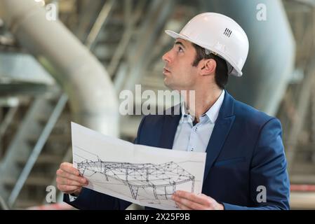 Porträt eines Architekten, der den Grundriss studiert Stockfoto