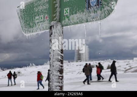 Schierke, Deutschland. April 2024. Eiszapfen bilden sich auf einem Wegweiser am Brocken. Eine kalte Wetterfront brachte viel Schnee in die höheren Höhen des Harzes. Am Samstag können Besucher des Brocken eine winterliche Landschaft genießen. Quelle: Matthias Bein/dpa/Alamy Live News Stockfoto