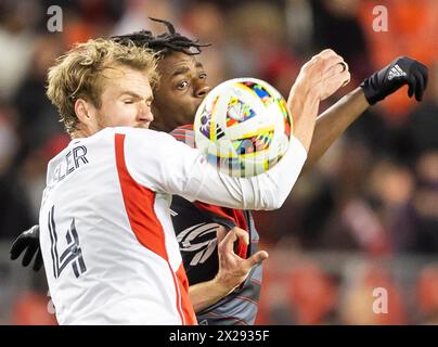 Toronto, Kanada. April 2024. DeAndre Kerr (zurück) vom Toronto FC streitet mit Henry Kessler von der New England Revolution während des Major League Soccer (MLS) Spiels 2024 zwischen Toronto FC und New England Revolution auf dem BMO Field in Toronto, Kanada, am 20. April 2024. Quelle: Zou Zheng/Xinhua/Alamy Live News Stockfoto