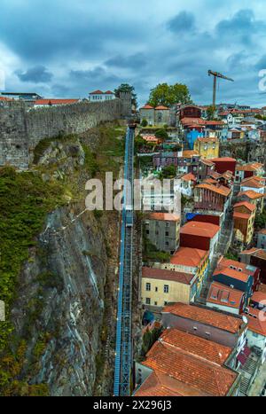 Blick aus der Vogelperspektive auf die Seilbahn dos Guindais und malerische Häuser, Barterrassen und Ziegeldächer im historischen Zentrum der Stadt Porto am Ufer Stockfoto