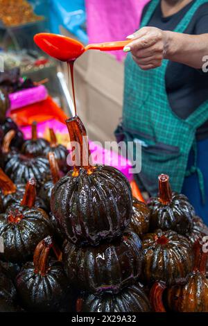 Frau, die Sirup über Sweet Calabaza gießt, auf dem Jamaica-Markt in mexiko-Stadt, Mexiko Stockfoto