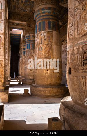 Luxor, Ägypten - 26. November 2023: Bunte Gemälde und Hieroglyphen zieren die Säulen im Tempel von Ramesses III. In Medinet Habu auf der Luxor westbank Stockfoto