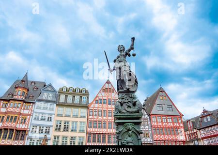 Frankfurt, Deutschland - 10. April 2024: Statue der Justizfrau mit dem alten Brunnen am Frankfurter römerplatz. Stockfoto