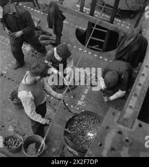 GLASGOW SHIPYARD: SCHIFFBAU IN KRIEGSZEITEN, GLASGOW, LANARKSHIRE, SCHOTTLAND, VEREINIGTES KÖNIGREICH, 1944 - Ein Team von Nietern, die hart arbeiten Stockfoto